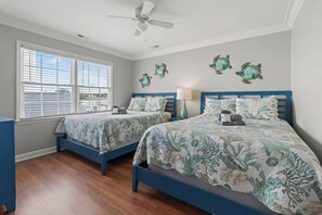 A bedroom with two beds, a ceiling fan, and a window with blinds. - License To Chill-Pool, Put-put,Game Table, Slps 20 (North Myrtle Beach)
