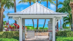 A gazebo with a view of the ocean, surrounded by palm trees and a pool area with rules posted. - PRIME LOCATION Islamorada Anglers Reef Oceanview Private Beaches, Pool & Marina (Islamorada)