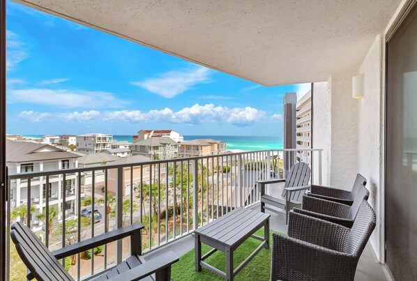 A balcony with a view of the ocean and buildings. - Mainsail 352 - Gulf Front Condo, Community Pool, Hot Tub, Free Beach Service! (Miramar Beach)