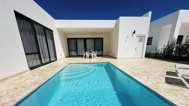 A rectangular swimming pool with clear blue water, surrounded by a light-colored tiled deck. - Coastal Luxe SOV: 3 Bed, 3.5 Bath, Sosúa Ocean Village (Sosúa)