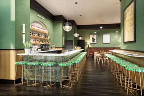 Relax with a drink at the hotel bar, featuring a stylish counter and comfortable stools.