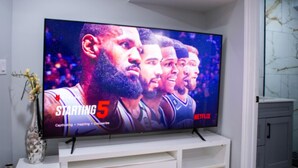 A flat-screen TV mounted on a white entertainment unit. - Cozy and Private Basement apartment / Ideal for Relaxation or Work (Brampton)