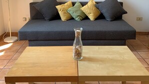 A living room with a grey sofa, a wooden coffee table, and a floor lamp. - Flat nearby Vaticano - Caracciolo 4 (Rome)