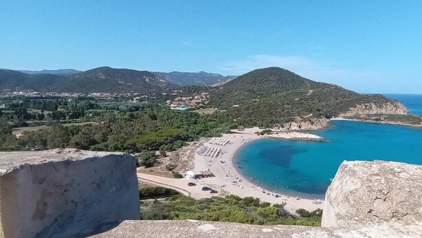 A coastal landscape with a beach, clear blue sea, and a mountainous backdrop. - Villetta Rosmarino 1700 meters from the wonderful beaches of Chia (Sardegna)