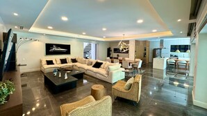 A spacious living room with a sectional sofa, a coffee table, and a dining area with a table and chairs. - Gorgeous Villa Marina Vallarta, pool, Free Shuttle (Puerto Vallarta)