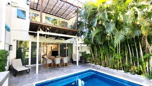 A two-story house with a swimming pool, outdoor seating, and lush tropical plants. - Gorgeous Villa Marina Vallarta, pool, Free Shuttle (Puerto Vallarta)