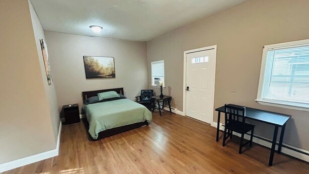 A bedroom with a bed, a desk, and a chair. - Large room with private bathroom near Whole Foods (Providence)