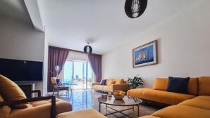 A modern living room with two sofas, a coffee table, and a TV. -  Casa Oliva Villas with Private Heated Pools and Guest Apartments-No Pool Access (Petrovac)