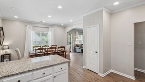 A spacious kitchen with granite countertops, wooden chairs, and a dining table. - Casa Azul Memphis Midtown Cooper Young (Memphis)