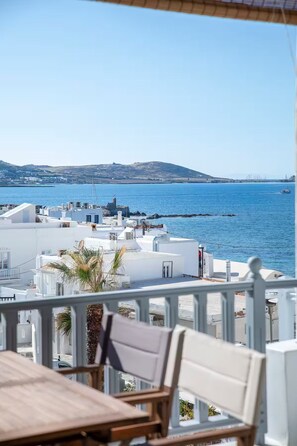 A terrace with a view of the sea and a distant hill. - Naousa | 2BR House with Amazing View | Caper (Naousa)
