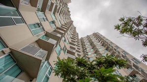 Un immeuble résidentiel de grande hauteur doté de nombreux balcons, de grandes fenêtres et d’une architecture moderne.