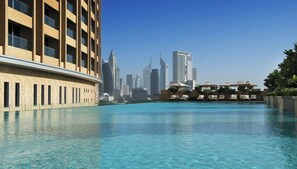 A swimming pool with a city skyline in the background.