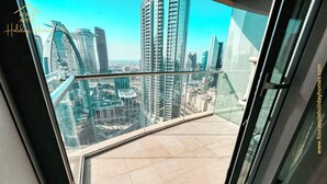 A balcony with a city view, featuring modern high-rise buildings. - Luxury Studio with Burj Khalifa View (Dubai)