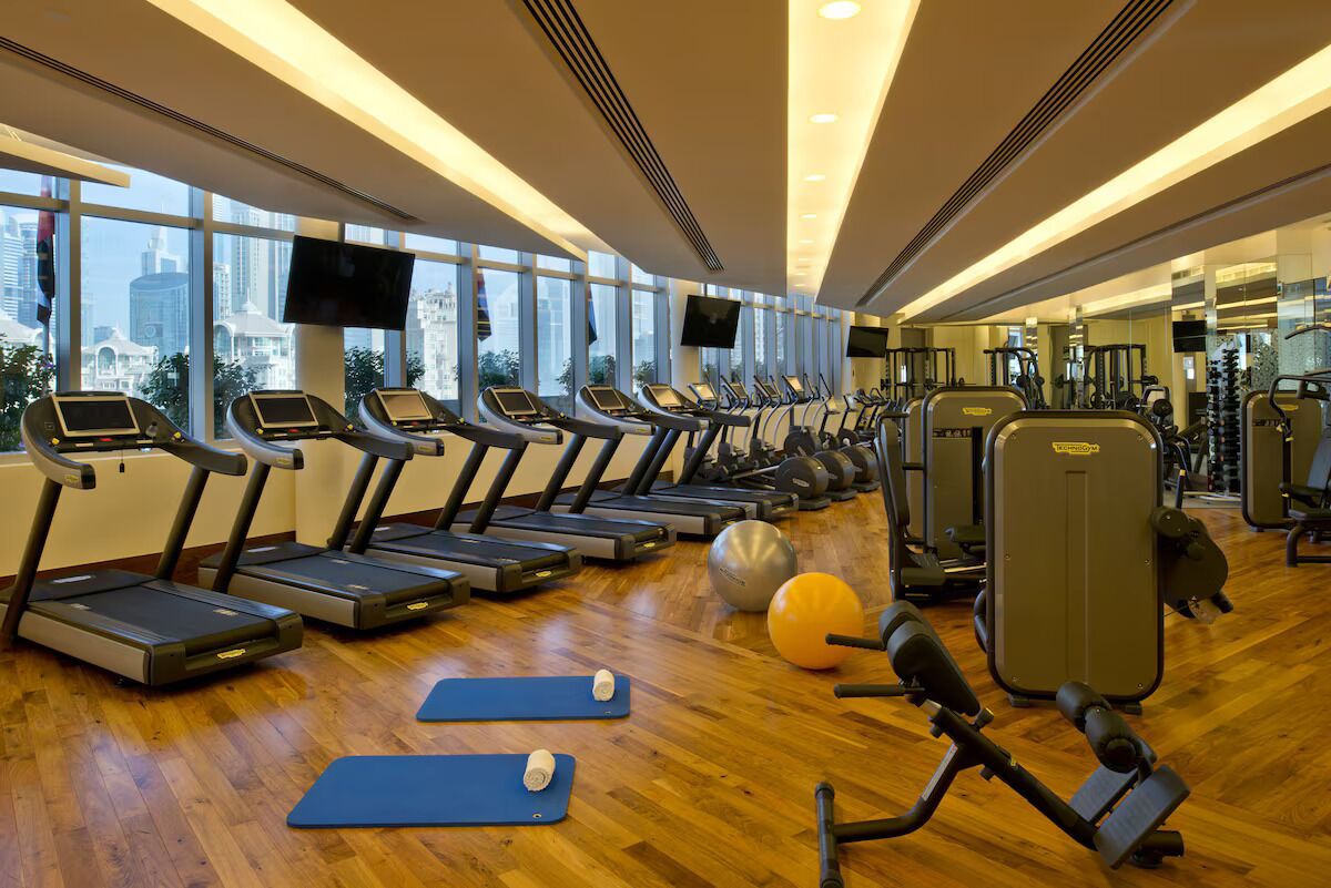 A gym with treadmills, exercise balls, and mats.