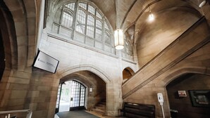 A spacious interior with high arched ceilings and large windows. - Knox Residence University of Toronto (Toronto)