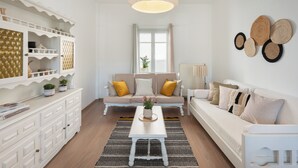 A modern living room with a sofa set, a coffee table, and decorative wall art. - Naousa | 2BR House in the Heart of Town | Citrine (Naousa)