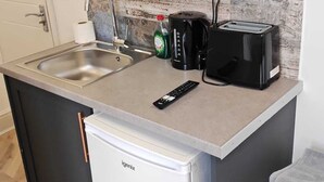 A compact kitchen with a microwave, coffee maker, toaster, and a small refrigerator. - Dalston Luxe Studios (3 Miles away from Liverpool Train Station) (London)