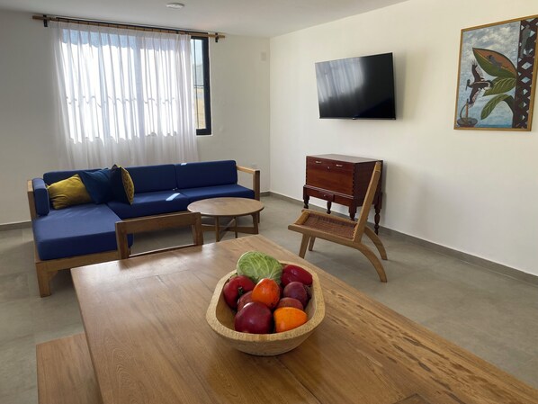 Relax in this stylish living room with a sofa, coffee table, and flat-screen TV.