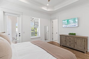A bedroom with a bed, a dresser, a television, and two windows with blinds. - Heated Private Pool*6-Seater Golf Cart*Steps2Beach (Santa Rosa Beach)