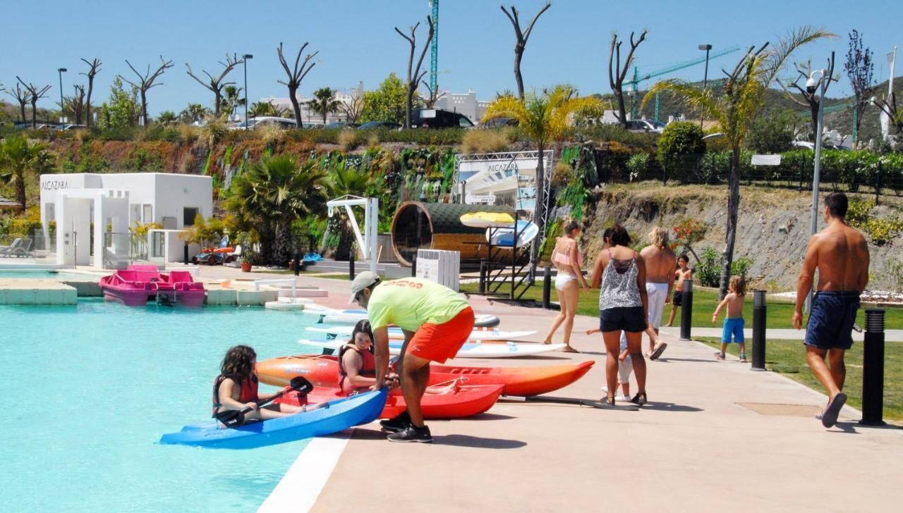 A pool area with kayaks and a lifeguard tower.