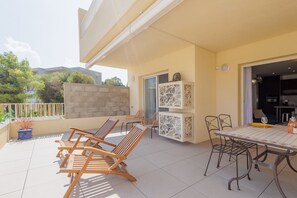 Relax in style on this inviting patio, featuring a lounge area with comfortable seating and a decorative panel.