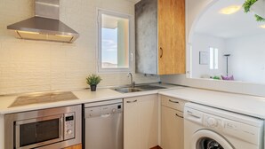 A modern kitchen with stainless steel appliances, a dishwasher, and a built-in oven. - Apartment 'El Mirador' with Sea View, Wi-Fi and Air Conditioning (Mutxamel)
