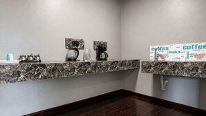 A modern kitchen with marble countertops, a coffee machine, and a coffee station. - Kitumo Mara Lodges  (Maasai Mara)