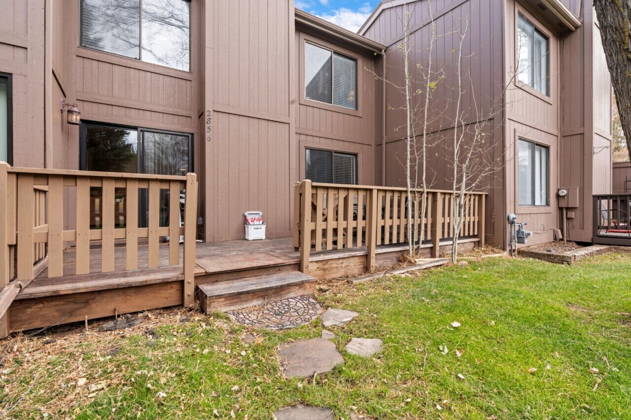 Un bâtiment à deux étages doté d’une terrasse en bois et d’un petit marchepied menant à l’entrée.