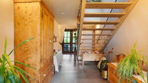 A wooden interior with a staircase, a radiator, and potted plants. - Room 'La Gemma - Stanza Del Fieno' with Mountain View, Shared Garden and Wi-Fi (Sant'Orsola Terme)