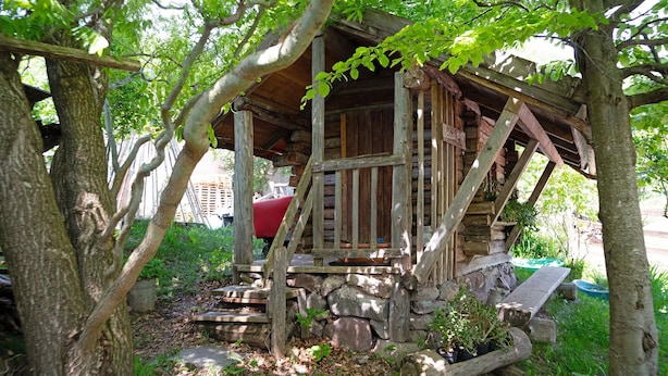 A rustic wooden structure with a stone foundation, surrounded by trees and greenery. - Room 'La Gemma - Stanza Del Fieno' with Mountain View, Shared Garden and Wi-Fi (Sant'Orsola Terme)