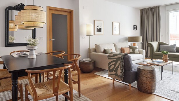 A modern living room with a dining area, featuring a wooden dining table, wicker chairs, a sofa, and a coffee table. - Muinoa 2 by FeelFree Rentals (San Sebastián)
