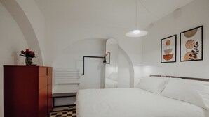 A bedroom with a bed, a dresser, a mirror, and two framed artworks on the wall. - Hidden House by Monholiday (Monopoli)