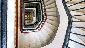 A spiral staircase with a central landing and a handrail on the left. - Downtown Gem - View of the old medina (Rabat)