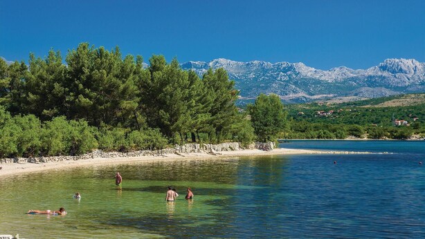 A clear lake with people swimming and a mountain range in the background. - 1 bedroom gorgeous apartment in Pridraga (Pridraga)