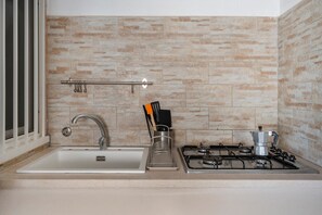 A kitchen with a sink, faucet, stove, and utensils. - Studio 'Carolina 1' with Shared Terrace, Wi-Fi and Air Conditioning (Monopoli)
