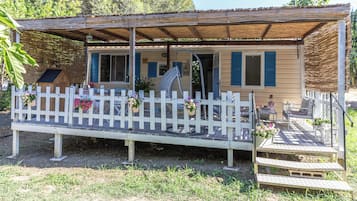Cozy cottage with a charming porch and covered seating area.