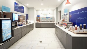A modern kitchen with a self-serve breakfast station, including yogurt, cereal, and milk dispensers. - Holiday Inn Express & Suites Waco Downtown by IHG (Waco)