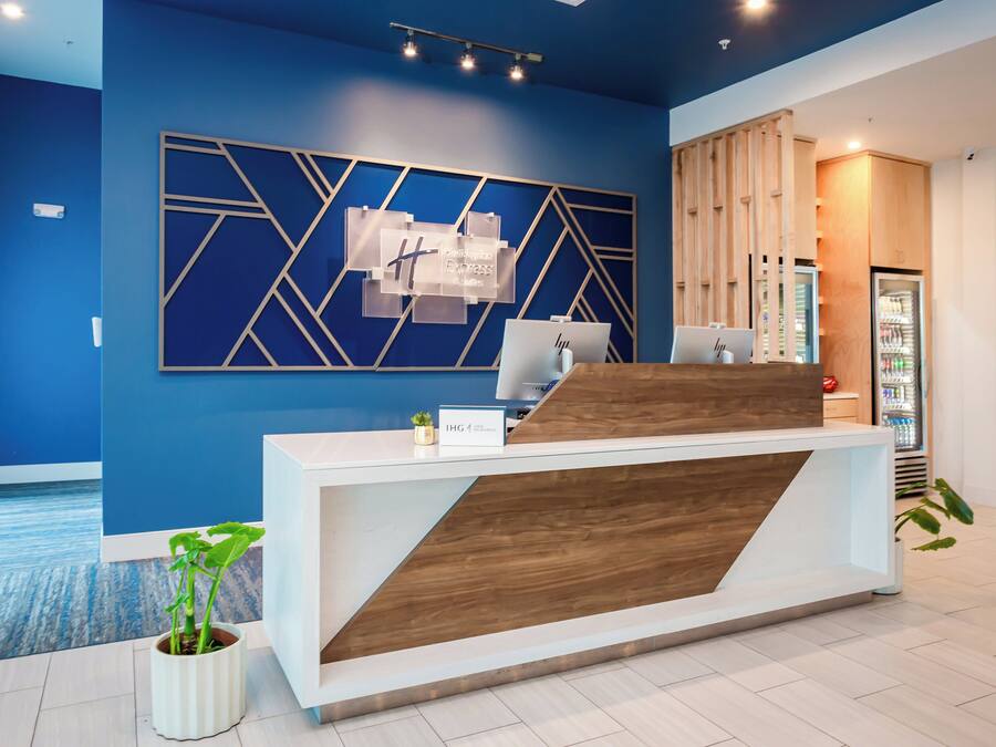 A modern reception desk with a blue wall and geometric decor.