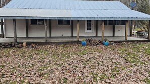A single-story building with a corrugated metal roof and a covered porch.