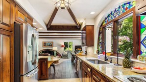 A modern kitchen with wooden cabinets, stainless steel appliances, and a large island. - Private Pool 5 Minutes From Lake Michigan (South Haven)