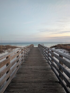 A wooden boardwalk leading to a beach with a clear view of the ocean. - Beach get away! Cozy 2-bedroom condo in Orange Beach, AL w/ WiFi, AC, fitness (Orange Beach)
