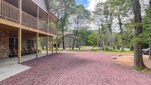 Un bâtiment doté d’un porche couvert et d’un espace extérieur aménagé pour s’asseoir.