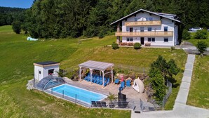 A two-story house with a swimming pool, outdoor seating, and a covered patio. - Marianne by Interhome (Sankt Englmar)