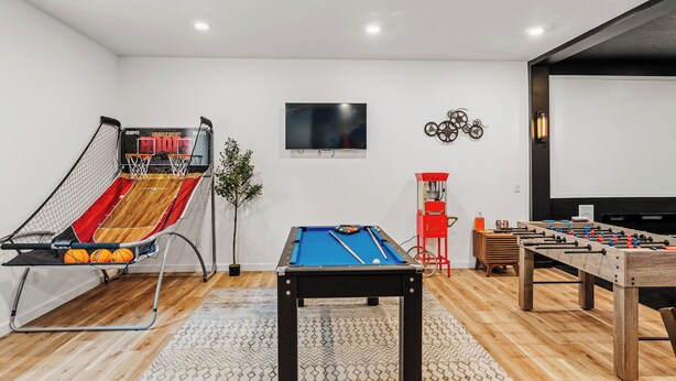 A recreational room with a pool table, foosball table, and a basketball arcade. - "Ultimate Luxe Escape with Private Movie Theater and Game Room" (Nelsonville)