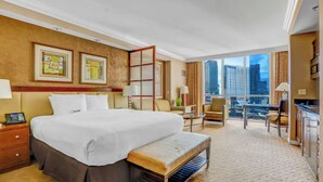 A hotel room with a large bed, a desk, a chair, a balcony with a view of the city, and a large window. - Sphere / F1 / Strip View/ MGM Signature Studio C21 (Las Vegas)