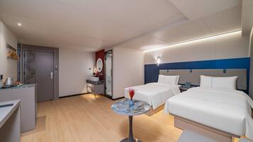 A hotel room with a bed, bedside tables, a desk, and a bathroom.
