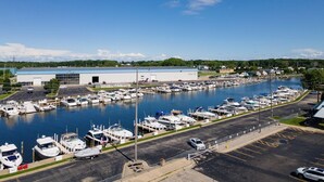 A marina with multiple boats docked, a large building labeled "Pier 33" in the background, and a parking area in the foreground. - Luxury Waterfront Condo (St. Joseph)