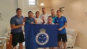 A group of people holding a blue banner with a logo, standing in a room with a white couch, a table with a tray, and a window. - House with 4 bedrooms for 10 people with all the comfort you need! (Asunción)
