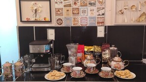A kitchen counter with a coffee maker, teapot, cups, and cookies. - House with 4 bedrooms for 10 people with all the comfort you need! (Asunción)