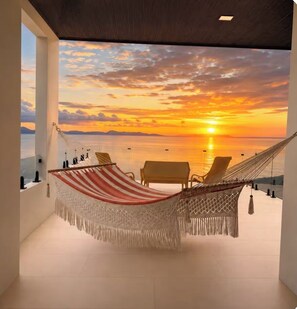 A hammock chair with a view of a sunset over water. - Luxury Villa w/ Ocean, Mountain Views, King Suites & Hot Tub - Sleeps 10 (Tarcoles)